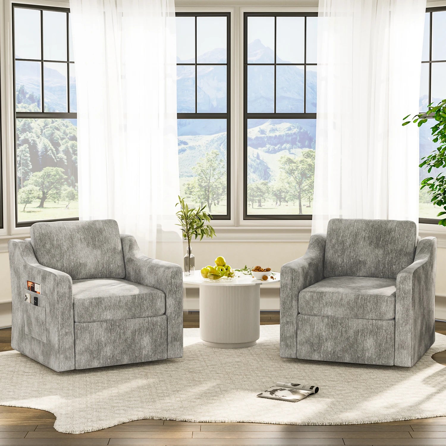 Two gray upholstered 360-degree swivel accent chairs with cushioned seats and back support beside a white round table.