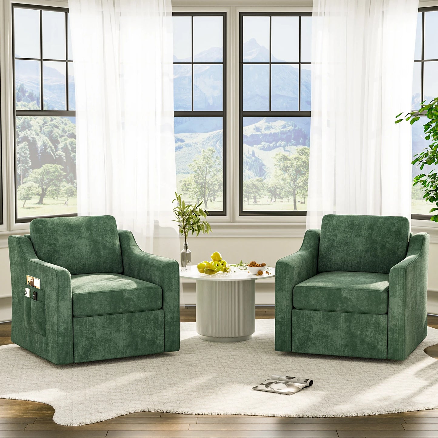 Two green 360-degree swivel upholstered accent armchairs around a white round table in a sunlit living room.