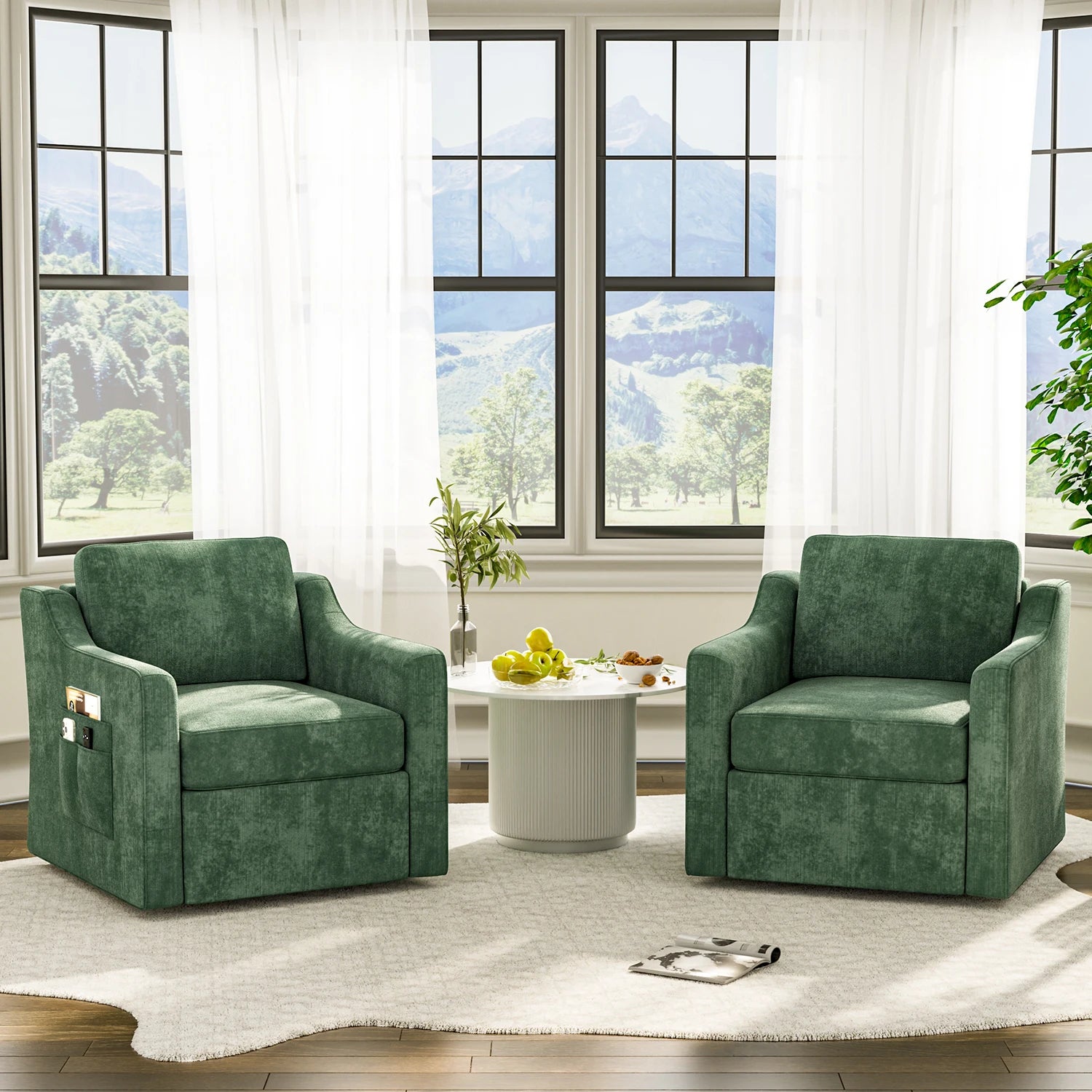 Two green 360-degree swivel upholstered accent armchairs around a white round table in a sunlit living room.